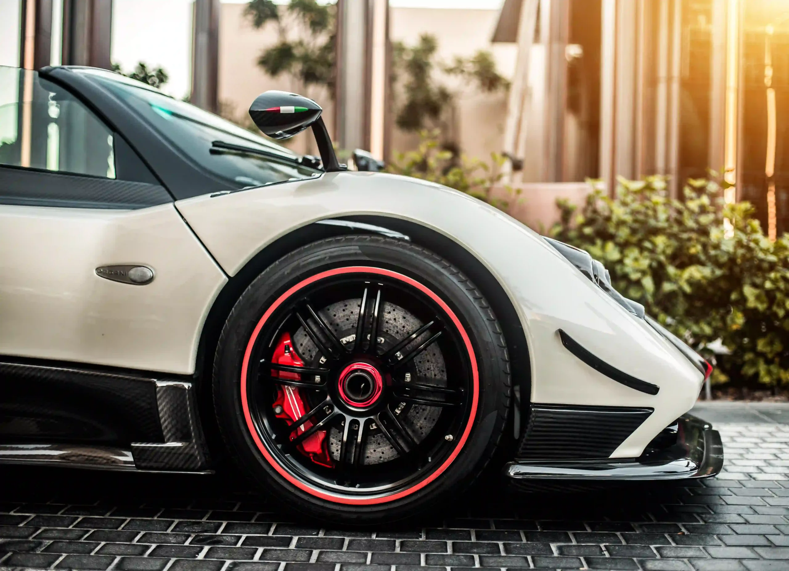 grey-silver-color-sport-car-front-side-view-with-red-wheels-road